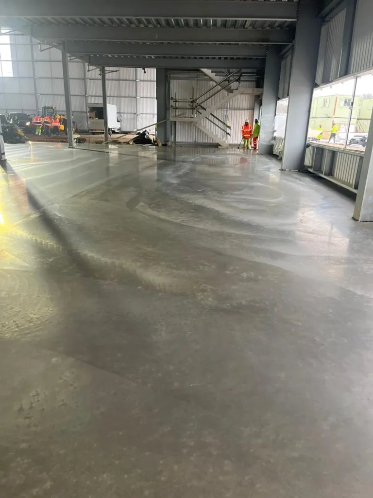 Jas2 Construction LTD workers finishing a concrete surface on a UK construction site